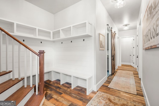 mudroom with hardwood / wood-style flooring and a barn door