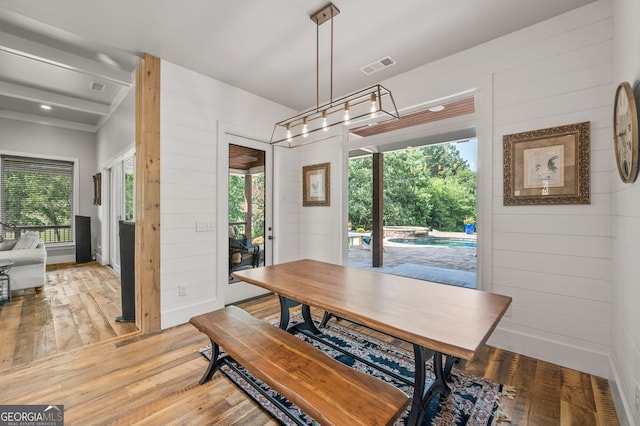 dining room featuring a healthy amount of sunlight and wood-type flooring