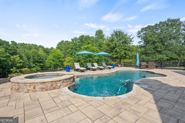 view of pool featuring an in ground hot tub and a patio area