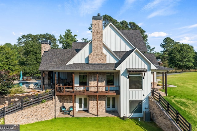 rear view of house featuring a balcony, a patio, central air condition unit, and a lawn