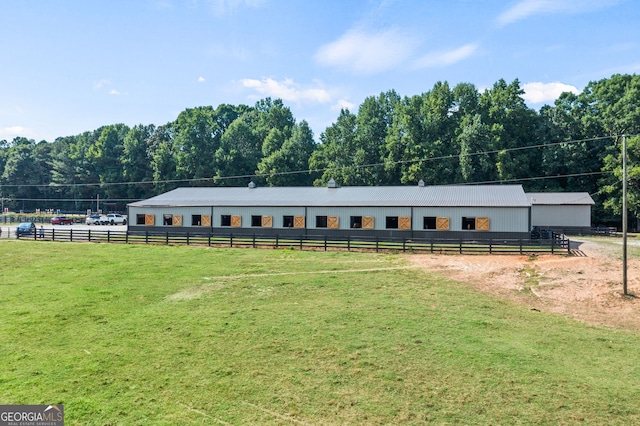 exterior space featuring a rural view and a front lawn