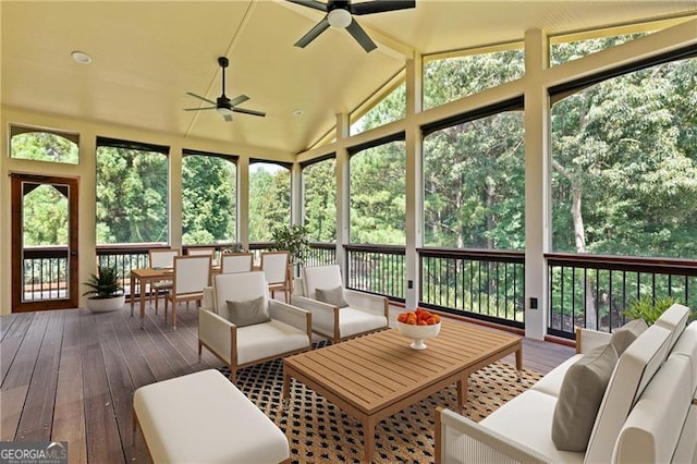 sunroom featuring ceiling fan, a healthy amount of sunlight, and vaulted ceiling