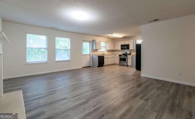 kitchen featuring black appliances, white cabinets, dark wood-type flooring, and a textured ceiling