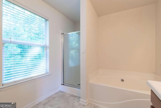 bathroom with a textured ceiling, a shower with shower door, and vanity