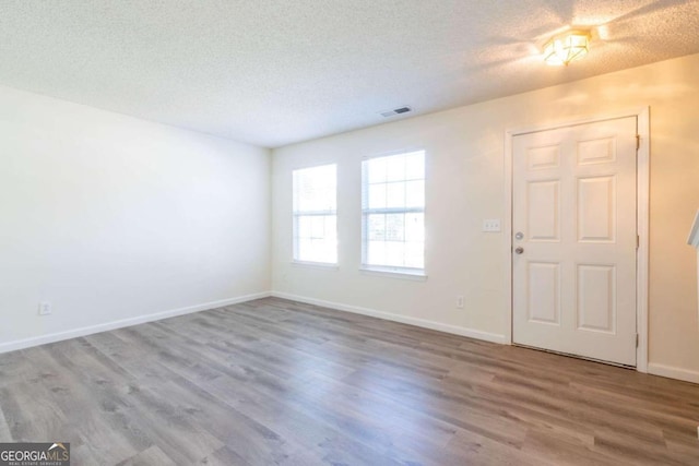 entrance foyer featuring a textured ceiling and hardwood / wood-style flooring