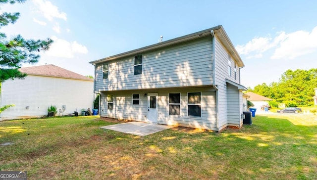 back of house with cooling unit, a yard, and a patio