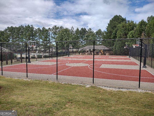 view of sport court featuring a lawn