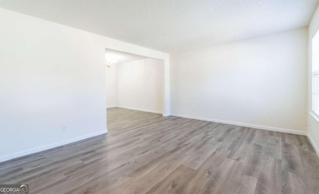 spare room with hardwood / wood-style flooring and a textured ceiling