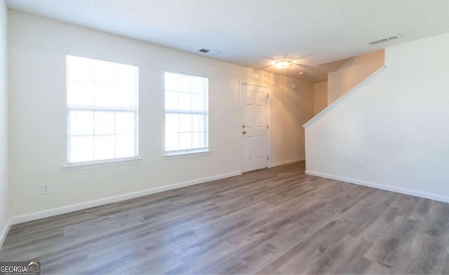 interior space featuring a textured ceiling and hardwood / wood-style floors