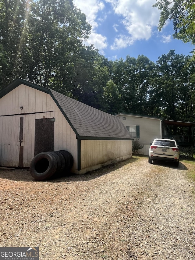 exterior space featuring an outbuilding and driveway