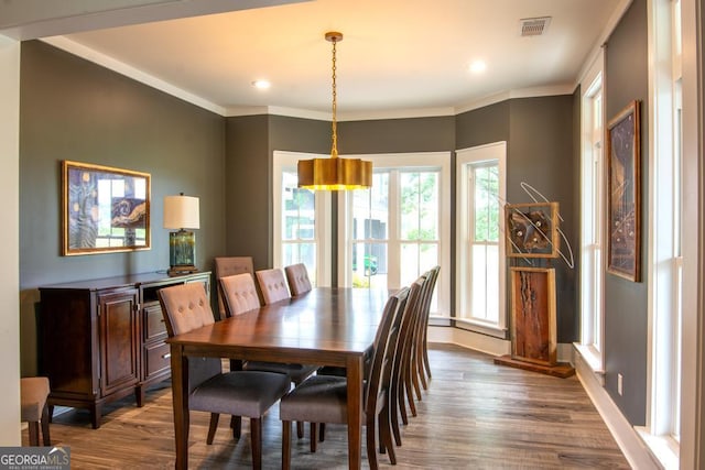 dining space featuring baseboards, crown molding, visible vents, and dark wood-type flooring