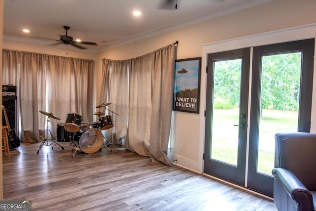 miscellaneous room with a healthy amount of sunlight, ceiling fan, crown molding, and wood finished floors