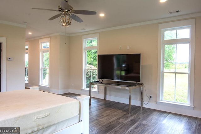 bedroom with baseboards, visible vents, dark wood-type flooring, crown molding, and recessed lighting