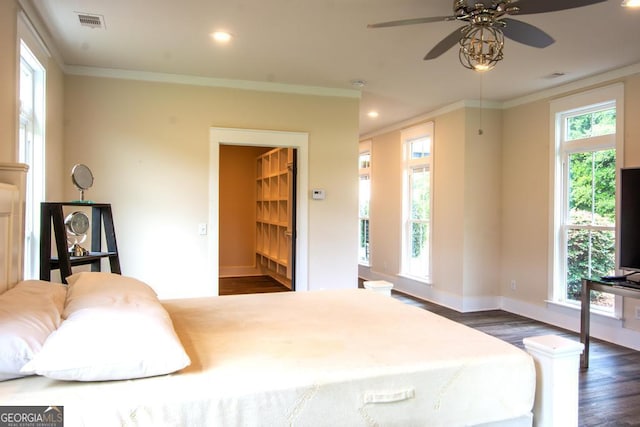 bedroom with ornamental molding, visible vents, and dark wood-style floors