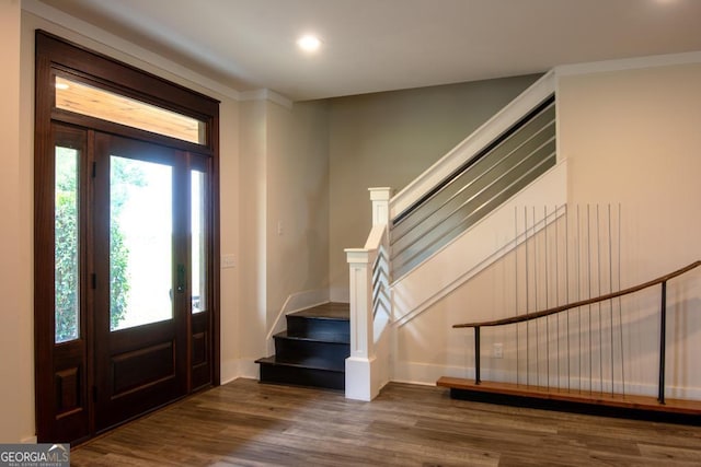 foyer entrance featuring stairs, dark wood finished floors, and recessed lighting