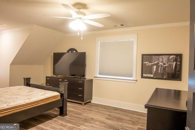 bedroom with baseboards, visible vents, a ceiling fan, ornamental molding, and wood finished floors