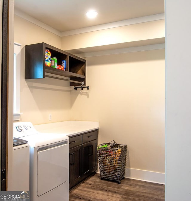 laundry area with cabinet space, baseboards, dark wood-type flooring, separate washer and dryer, and recessed lighting