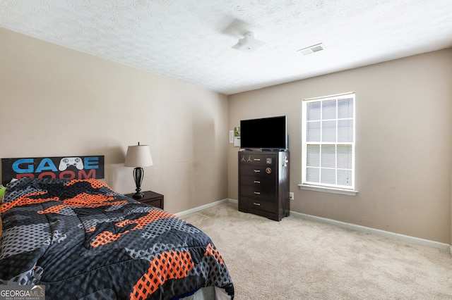 carpeted bedroom featuring a textured ceiling