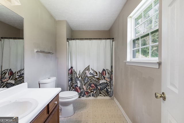 bathroom featuring tile patterned floors, toilet, vanity, and curtained shower