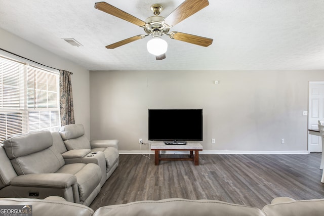 living room featuring ceiling fan, a textured ceiling, and hardwood / wood-style flooring