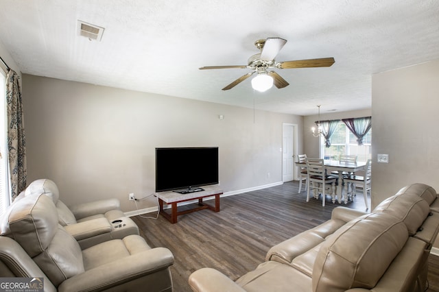 living room with a textured ceiling, ceiling fan with notable chandelier, and dark hardwood / wood-style flooring