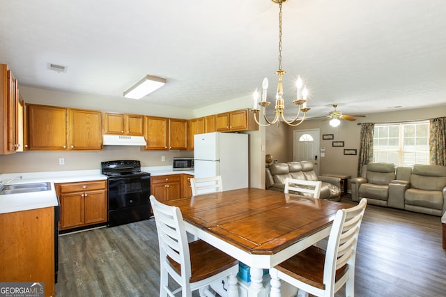 kitchen with dark hardwood / wood-style floors, sink, black range with electric stovetop, ceiling fan with notable chandelier, and white refrigerator