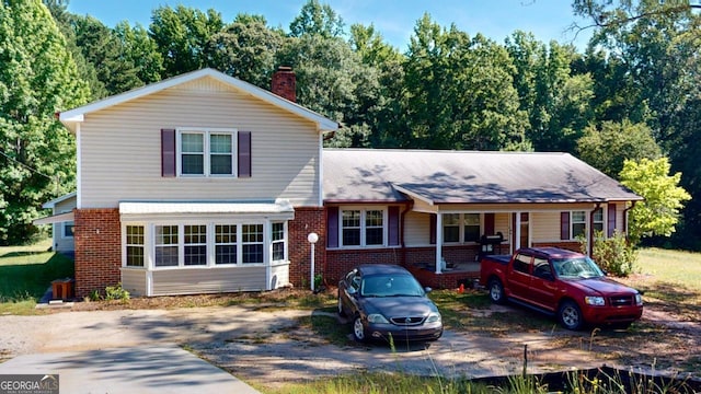 5110 Macland Rd, Powder Springs, GA 30127 - view of front facade featuring brick siding, a chimney, and covered porch