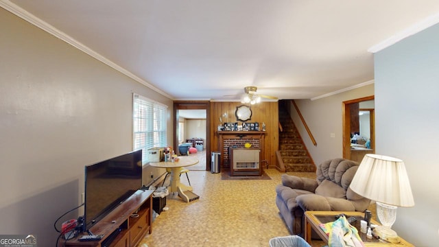 living room featuring crown molding, a fireplace, and ceiling fan