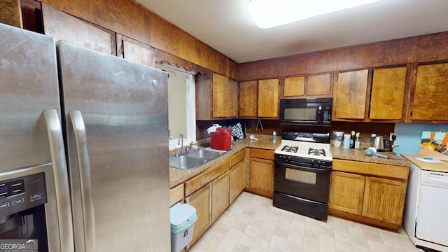 5110 Macland Rd, Powder Springs, GA 30127 - kitchen featuring range with gas cooktop, black microwave, stainless steel fridge with ice dispenser, a sink, and brown cabinets