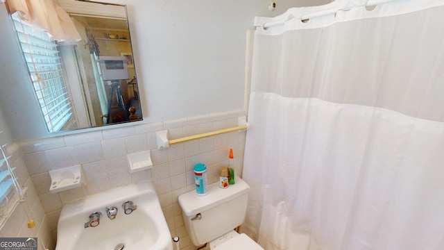 bathroom featuring tile walls and toilet