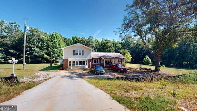 5110 Macland Rd, Powder Springs, GA 30127 - view of front of home featuring driveway, brick siding, a chimney, and a front lawn