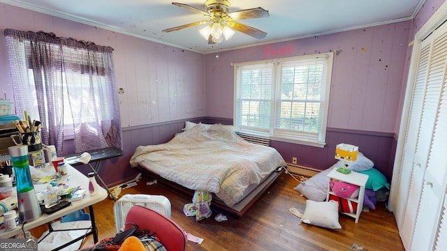 5110 Macland Rd, Powder Springs, GA 30127 - bedroom featuring crown molding, wood finished floors, baseboard heating, a ceiling fan, and wood walls