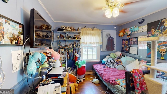 bedroom with baseboard heating, crown molding, hardwood / wood-style floors, and ceiling fan