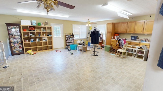 interior space featuring light tile patterned floors and ceiling fan