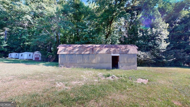 view of outbuilding featuring a lawn