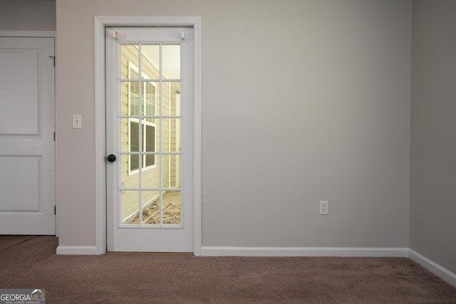 doorway to outside featuring carpet floors