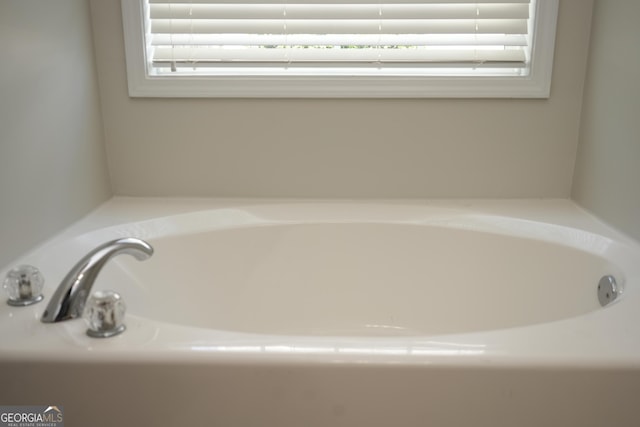 bathroom with a tub to relax in