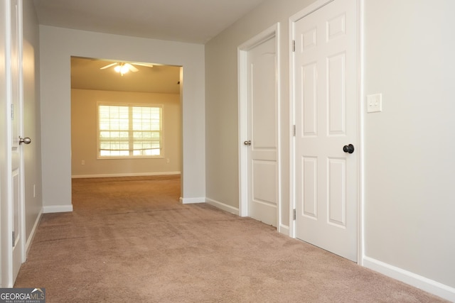 hallway featuring light colored carpet