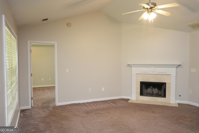 unfurnished living room with lofted ceiling, a fireplace, carpet floors, and ceiling fan