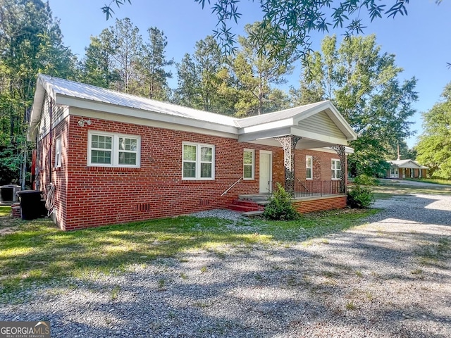 view of front of property with covered porch and central air condition unit