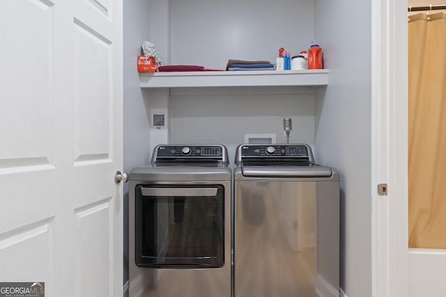 clothes washing area featuring washer and dryer