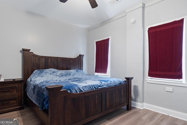 bedroom with ceiling fan and light hardwood / wood-style flooring