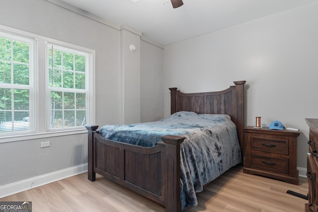 bedroom with multiple windows, ceiling fan, and light hardwood / wood-style flooring