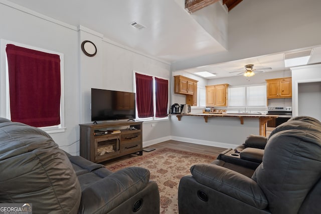 living room featuring ceiling fan and light hardwood / wood-style flooring