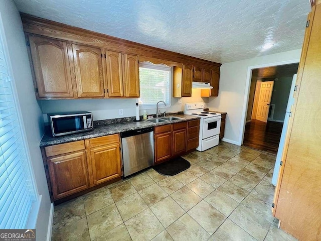 kitchen featuring light hardwood / wood-style floors, sink, a textured ceiling, and stainless steel appliances