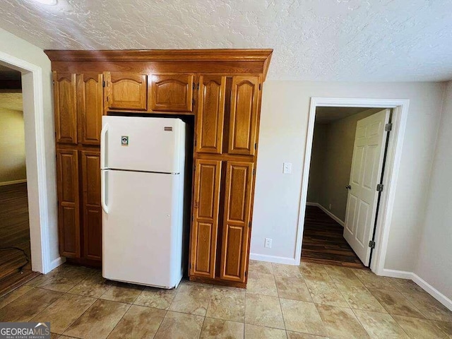 kitchen featuring white fridge and light tile patterned floors