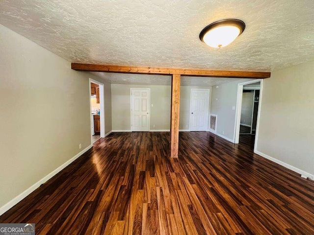 unfurnished bedroom with dark hardwood / wood-style floors, a closet, and a textured ceiling