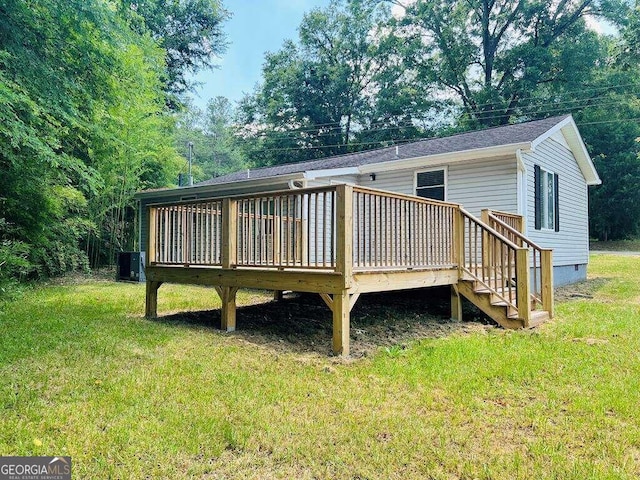 back of property with a yard and a deck