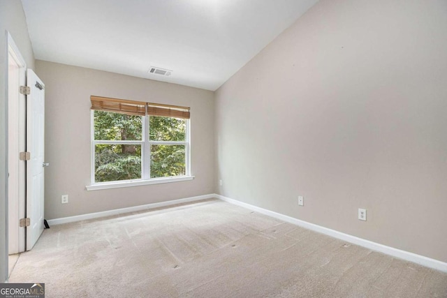 unfurnished room featuring light carpet