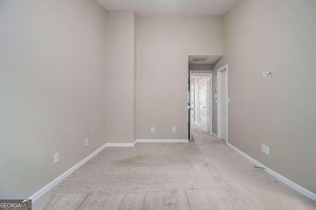 spare room with light colored carpet